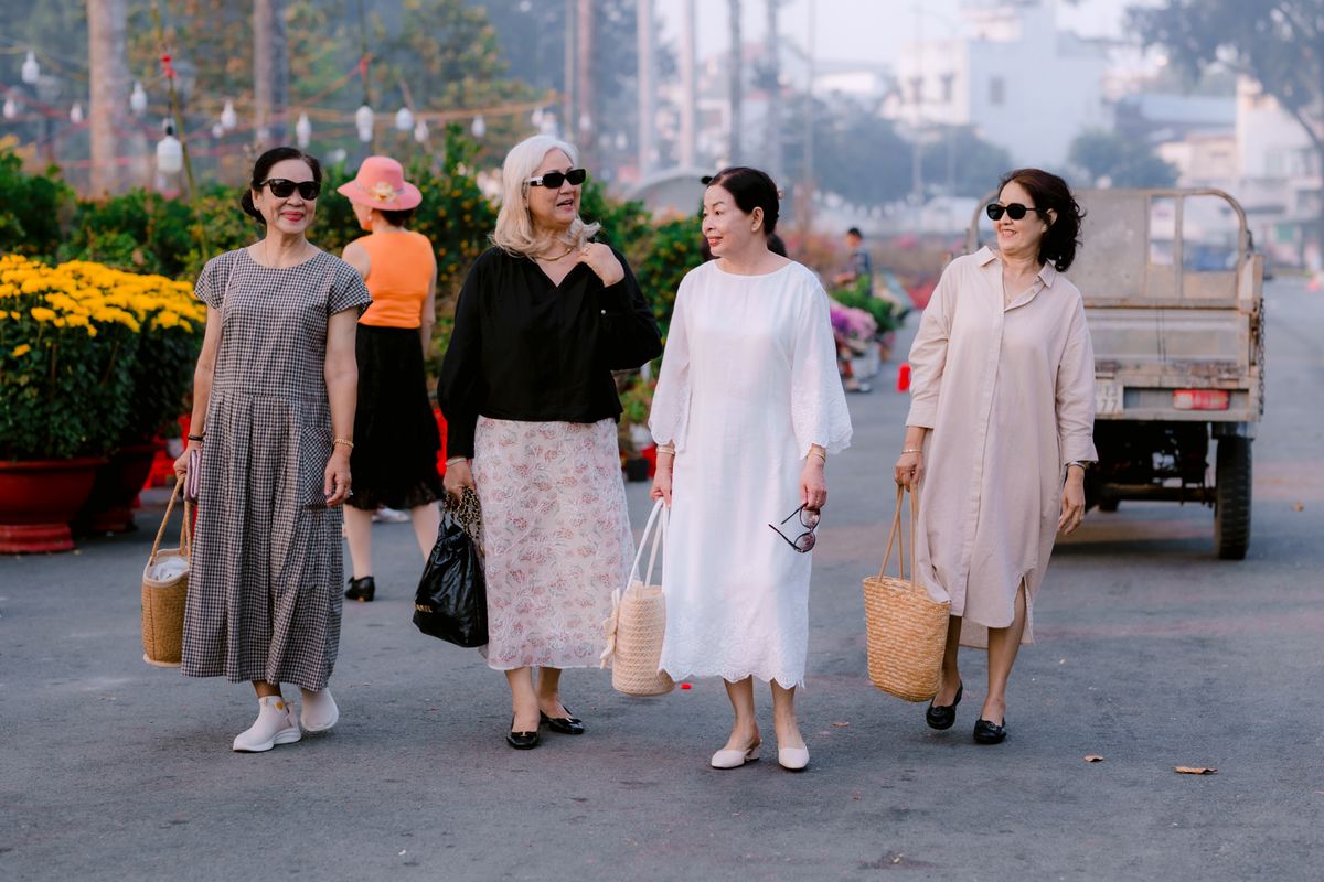 A group of mature women walking and talking outdoors